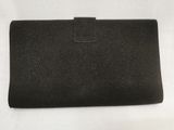 an image of a black leather wallet with a clasp on it