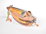 a small wooden boat with a string attached to it