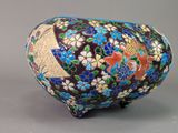 a vase with a design of flowers and birds on it