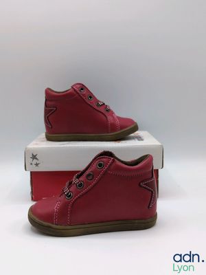 two pairs of red shoes sitting on top of a white box