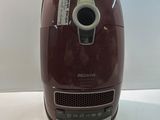 a red toaster that is sitting on a table