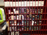 a red shelving that has many different types of cigarettes on it