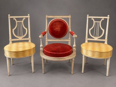 three chairs with red velvet cushions and a gold frame
