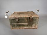 an old metal box with a handle on a table