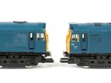 two blue and yellow train cars on a white surface