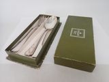 a green box with a spoon and fork in it