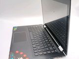a laptop computer sitting on a table with a keyboard