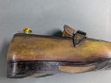 a wooden shoe that is on display on the wall