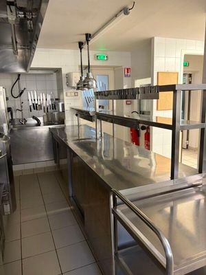 a kitchen with stainless steel counter tops and stainless steel appliances