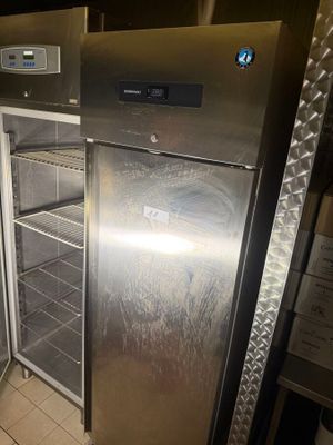 a silver refrigerator that is inside of a kitchen