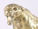 a gold statue of a lion with its mouth open