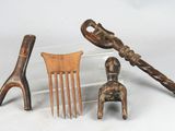 several pieces of wood are sitting on a table next to a pair of scissors and a comb