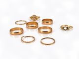 a lot of gold rings on a white surface