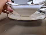 a person that is holding a cup and saucer