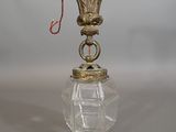 a small glass vase with a red cord hanging from it