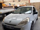 a picture of a car in a garage with a truck in the background
