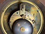 a close up of a clock with a pendulum on it