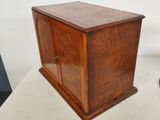 an old wooden cabinet with a door on top of it