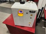 a small white refrigerator sitting on top of a red box