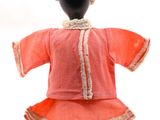 un mannequin vêtu d'une robe rouge et d'un chapeau