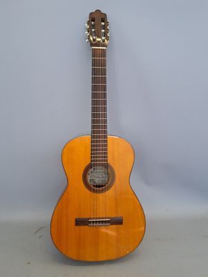 an image of a guitar sitting on top of a white surface