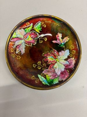une photo d'une assiette décorative sur laquelle sont peints des fleurs et des papillons