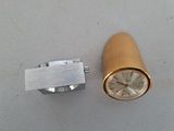 a small metal object with a clock inside of it