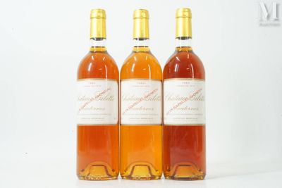 three bottles of wine sitting next to each other on a white surface