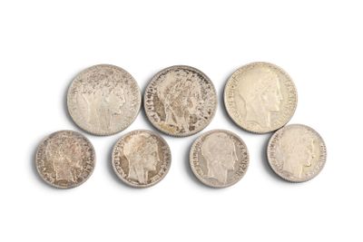 six different types of silver coins on a white surface