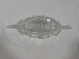 a glass bowl with a lid on a white surface