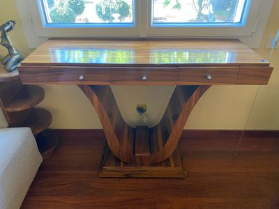 a wooden table with a glass top in a living room