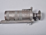 a small metal object that is on a white surface
