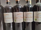several bottles of wine are lined up in a row on a shelf