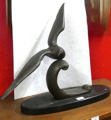 a sculpture of a bird that is sitting on a table