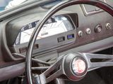 steering wheel and dashboard of a car with a clock on the dash