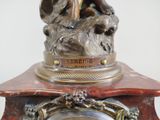a statue of a woman sitting on top of a clock