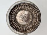 an overhead view of a silver plate on a white surface