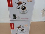 two boxes of coffee on the floor next to each other