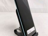 a phone that is sitting on a stand on a table
