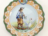 a plate with a picture of a man and a goose on it