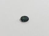 a green tourmaline gemstone on a white surface