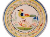 a colorful plate with a bird on it on a white background