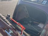 a car that has a bike in the back of it