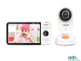 a close up of a baby monitor sitting next to a cell phone