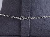 a close up view of a black hat with a silver chain on it