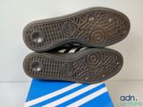 two pairs of shoes sitting on top of a blue and white box