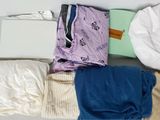 many different types of cloths laid out on a table