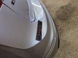 a close up of a car ' s tail light on the side of the car