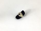 black and white ring with a silver heart on a white surface