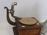 an old fashioned record player sitting on top of a wooden table
